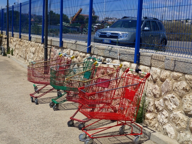 Shopping trolleys tethered to the wall at Marina Sant'Elmo