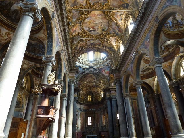 Incredible wealth in the church, this one has statues on the ceiling  (and lots of them)