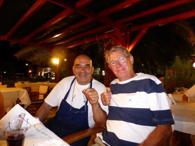 Discussing lamb with Chef at Petrino's on Leros.